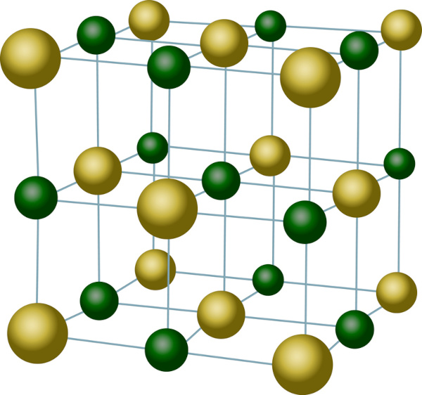 Esferas verdes e amarelas representando a estrutura do NaCl em texto sobre fórmulas químicas.