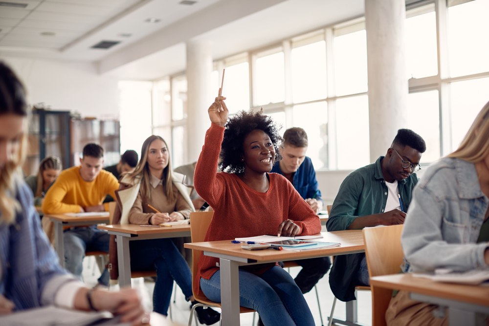 politica-cotas-combate-desigualdade Jovens de várias etnias sorrindo na sala de aula